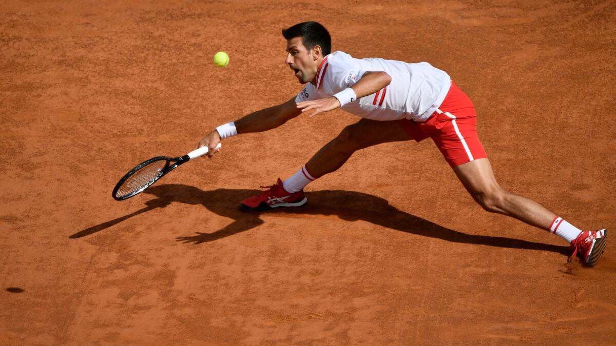 Novak Djokovic plays a forehand return to Alejandro Davidovich. (AFP)