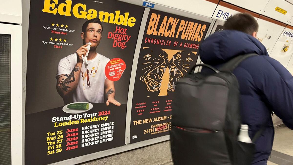 A view of a poster advertising comedian Ed Gamble's Hot Diggity Dog tour on the Bakerloo line platform at Embankment underground station in London on Wednesday. — AP