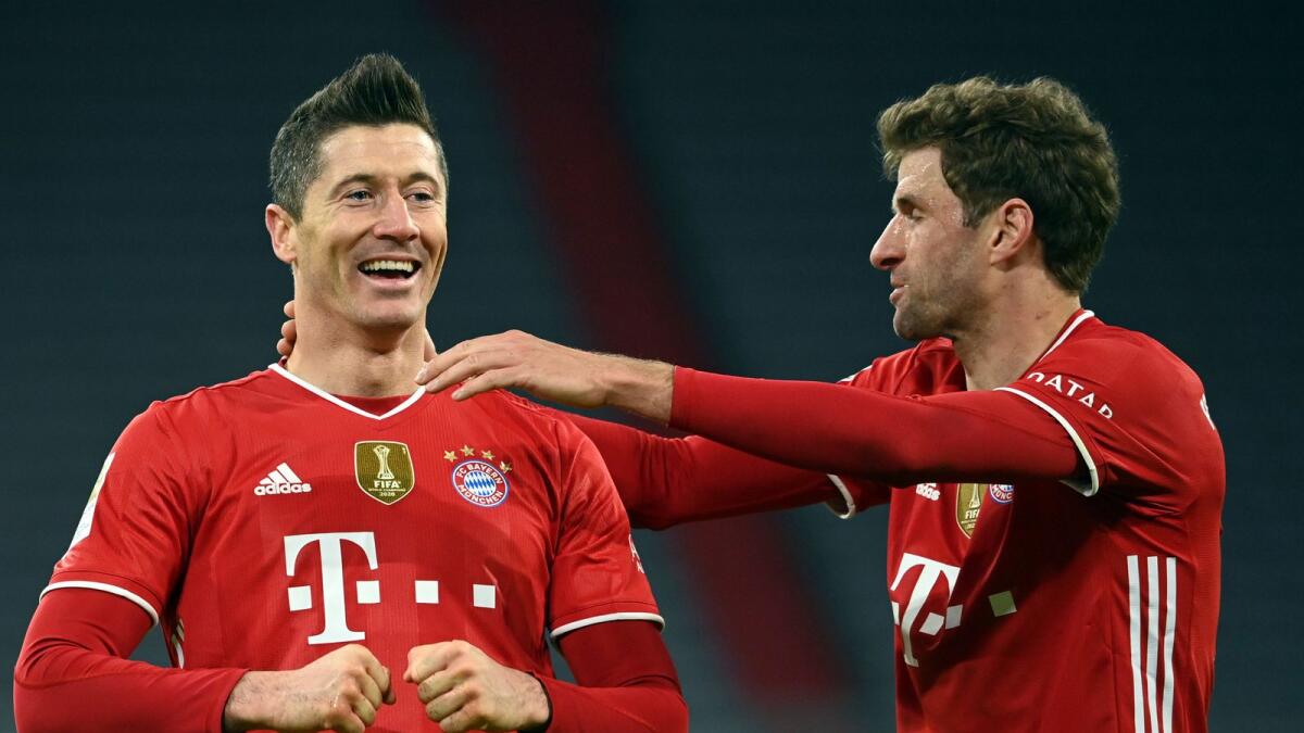 Bayern's Robert Lewandowski celebrates his one of the goals with Thomas Mueller. — AP