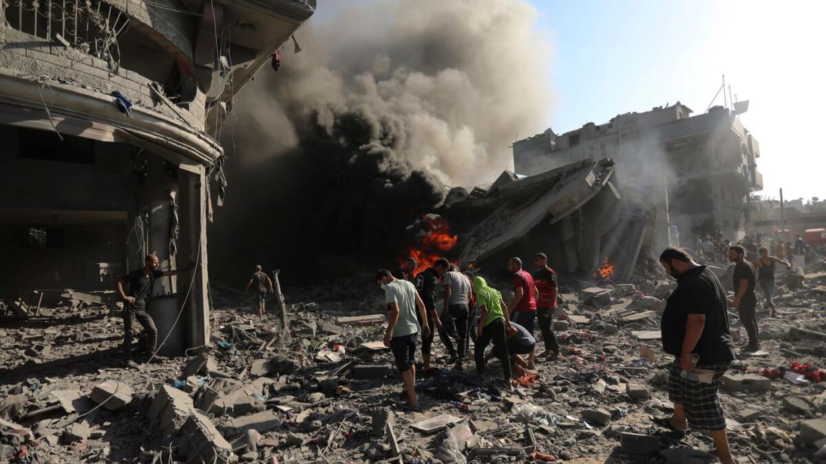 Palestinians inspect the damage of a house destroyed by an Israeli airstrike in Gaza City, Saturday, Nov. 4, 2023. AP
