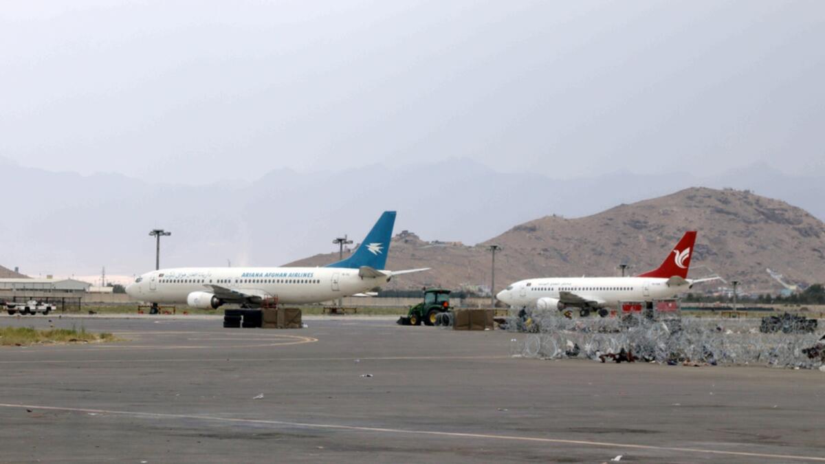 Aircraft are parked on the tarmac of the Hamid Karzai International Airport. — AP