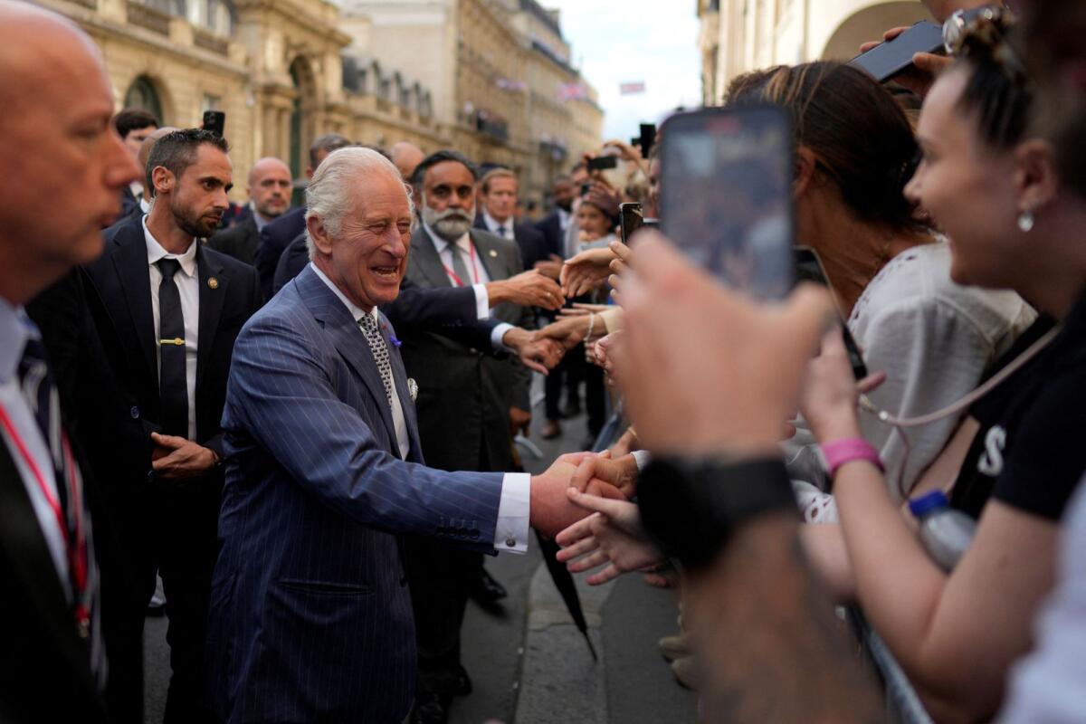 Britain’s King Charles III cheers residents during a walk from the Elysee Palace to the British ambassador to France’s residence,  Wednesday, Sept. 20, 2023 in Paris. Photo: Reuters