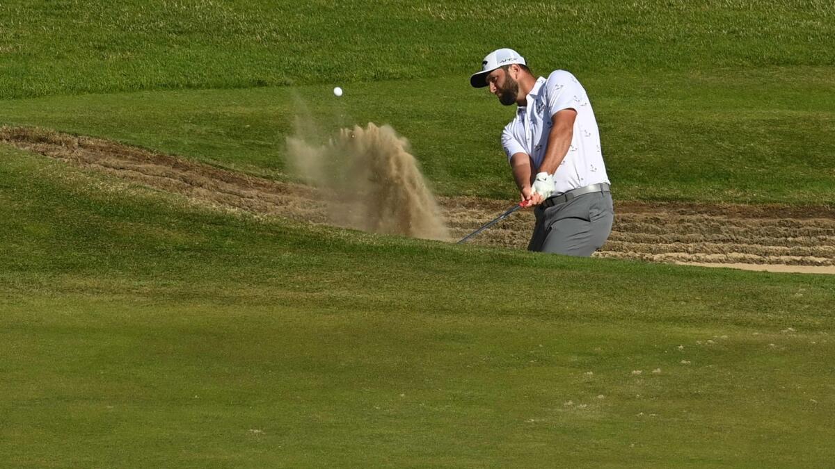 Spain's Jon Rahm hits out the bunker onto the 11th green during his third round on day 3 of The 149th British Open Golf Championship. — AFP