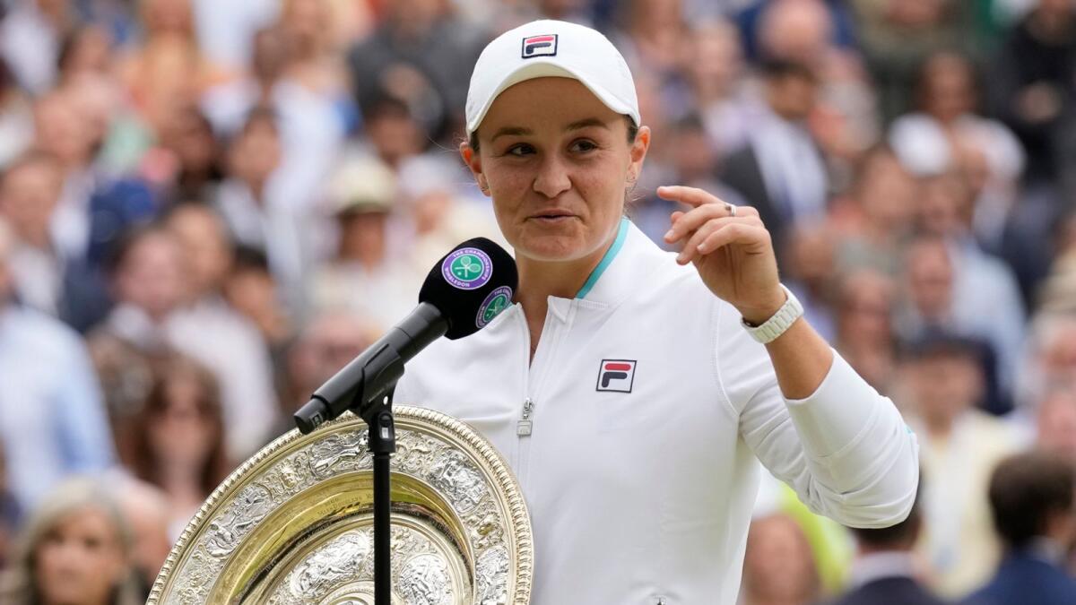Australia's Ashleigh Barty speaks to the media holding the trophy after winning the women's title in London. — AP