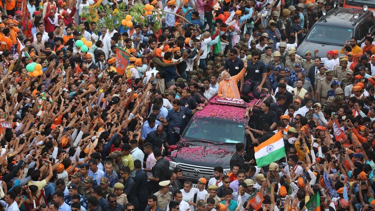 Indian Prime Minister Narendra Modi waves to the crowd during a political campaign road show in Varanasi, India.-AP 