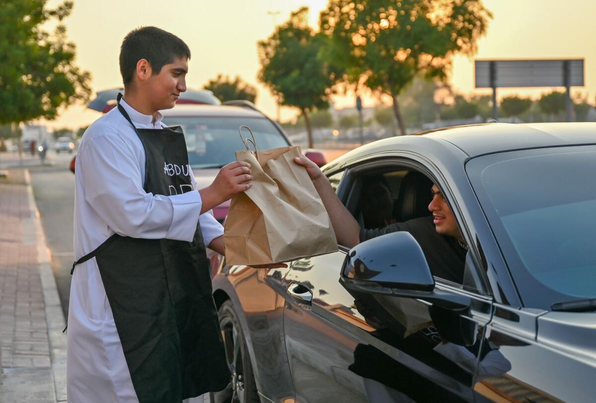 Abdulla AlJanahi delivers food to a customer in Dubai. — Photo by M Sajjad