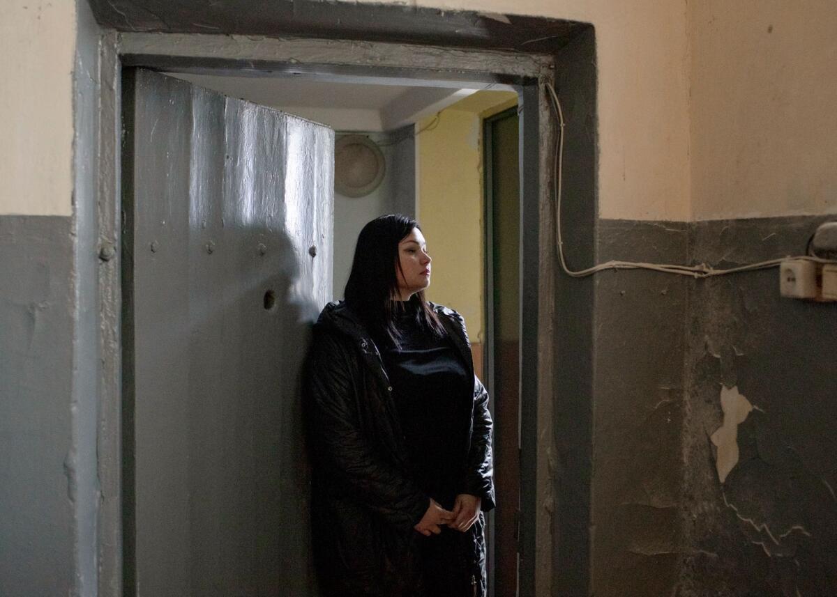 Albina Strelets stands in the holding cell of a police station in Balakliya, Ukraine where she had been held captive by Russian forces during their occupation of the town, on November 4, 2022. “I really wanted this area to be liberated,” said Strelets, who was detained after she transmitted information to the Ukrainian side. (Emile Ducke/The New York Times)