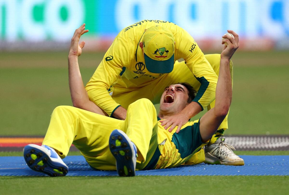 Australia's Pat Cummins celebrates a wicket with Manus Labuschagne in the semifinal against South Africa. — Reuters