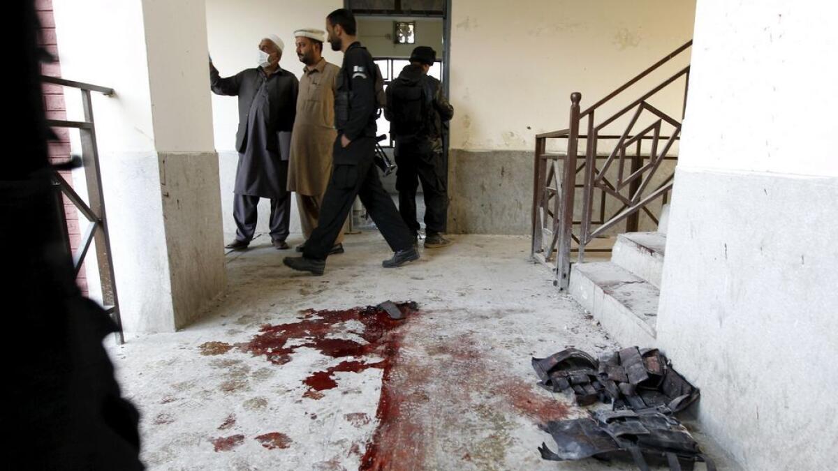 Blood stains and flak jackets used by attackers remain in the hallway of a dormitory where a militant attack took place, at Bacha Khan University in Charsadda, Pakistan. 