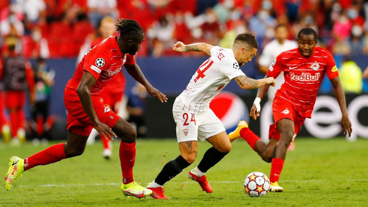 Sevilla's Alejandro Gomez in action with FC Salzburg's Oumar Solet and Mohamed Camara. — Reuters