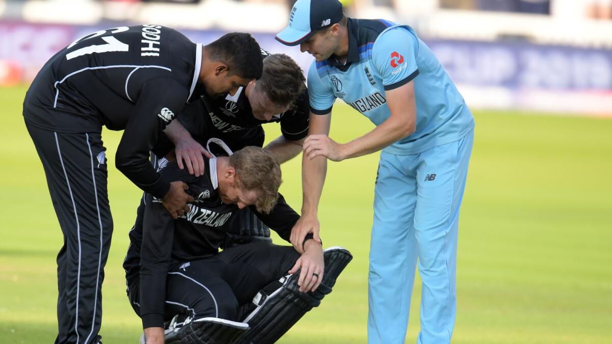 New Zealand's Martin Guptill (centre) is consoled by teammates and England's Chris Woakes (right) after the team's heartbreaking defeat in the 2019 ODI World Cup final. (AFP file)