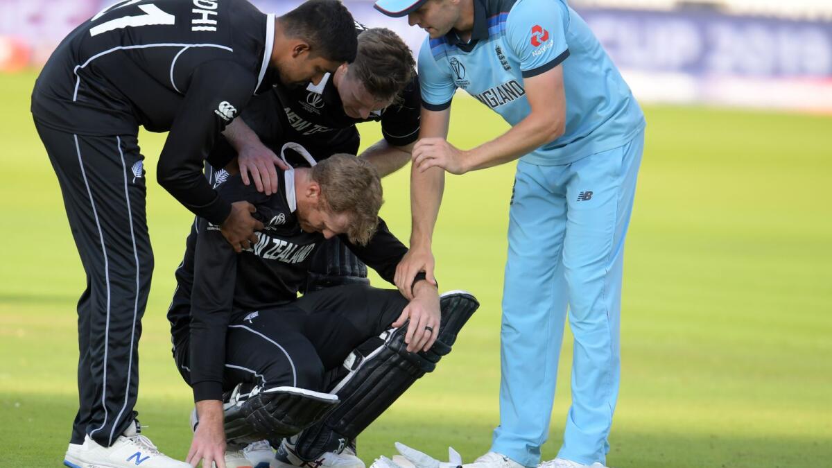 New Zealand's Martin Guptill (centre) is consoled by teammates and England's Chris Woakes (right) after the team's heartbreaking defeat in the 2019 ODI World Cup final. (AFP file)