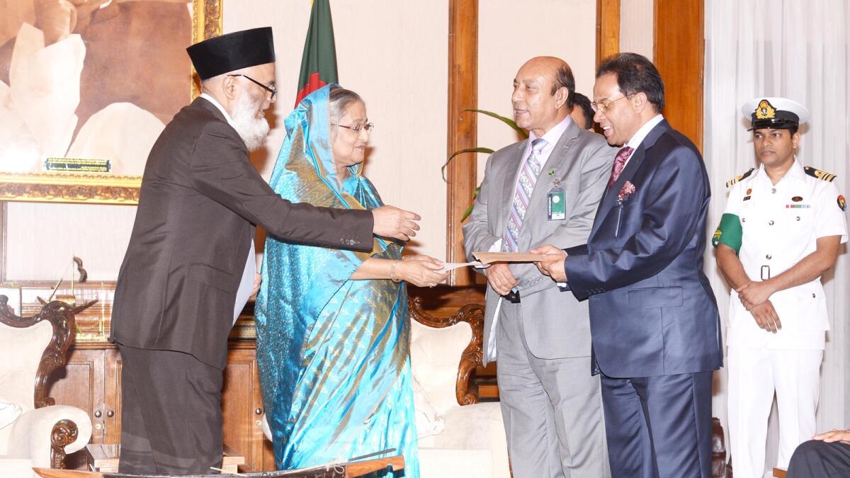 Rahman hands over a cheque for 500,000 takas to Sheikh Hasina Wazed, Prime Minister of Bangladesh, towards the prime minister’s relief fund in September 2014.