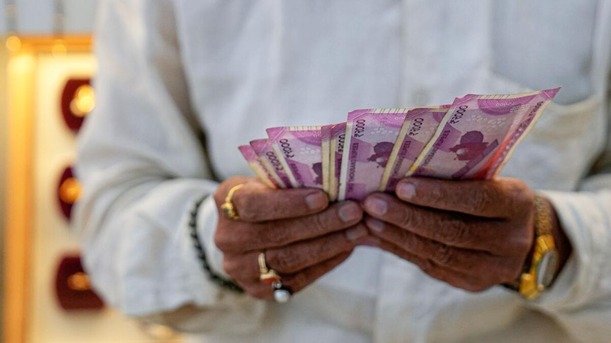 A shopkeeper counts Rs2,000 currency notes at a jewellery shop in Mumbai on Tuesday, Photo: PTI