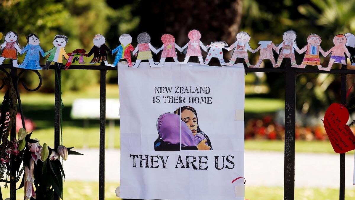 A poster hangs at a memorial site for victims of the shooting, in front of Christchurch Botanic Gardens in Christchurch, New Zealand.- Reuters