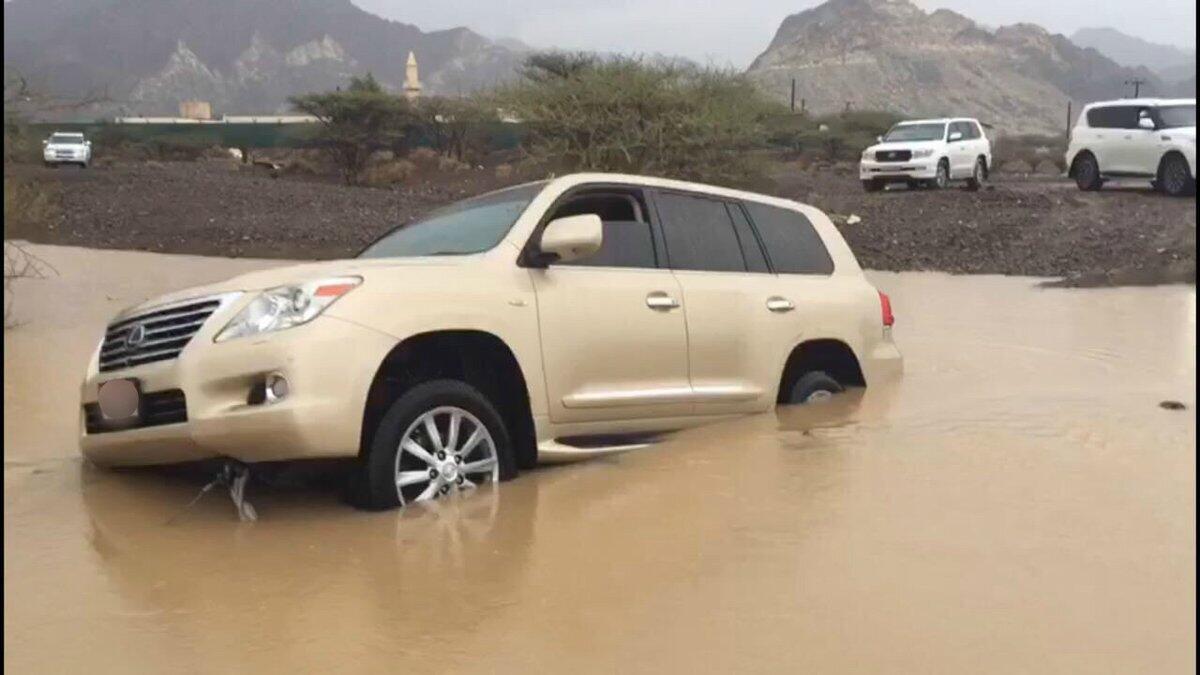 Dubai cops rescue motorist trapped in car in flooded valley 