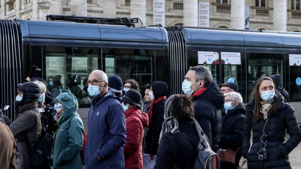 A group of tourists wearing the mask stand in front of the Grand Theatre in Bordeaux, southern France. — AFP