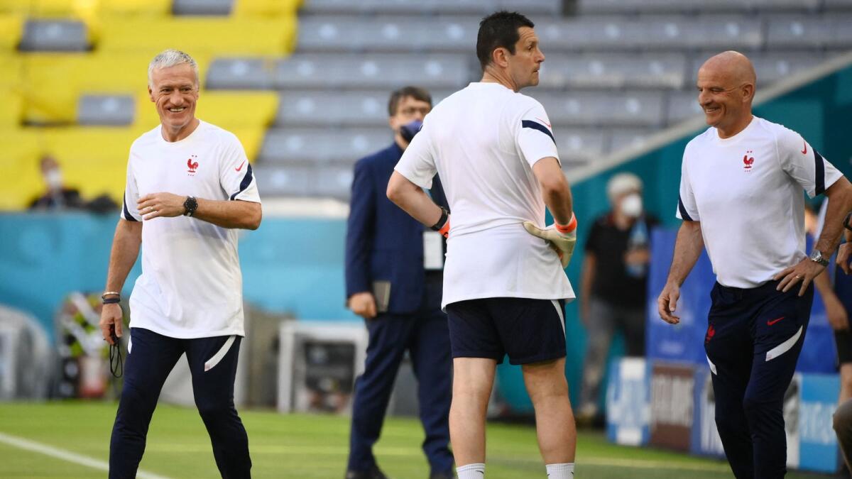 France's coach Didier Deschamps (left) and his assistant coach Guy Stephan (right) smile during a training session at the Allianz Arena in Munich. — AFP