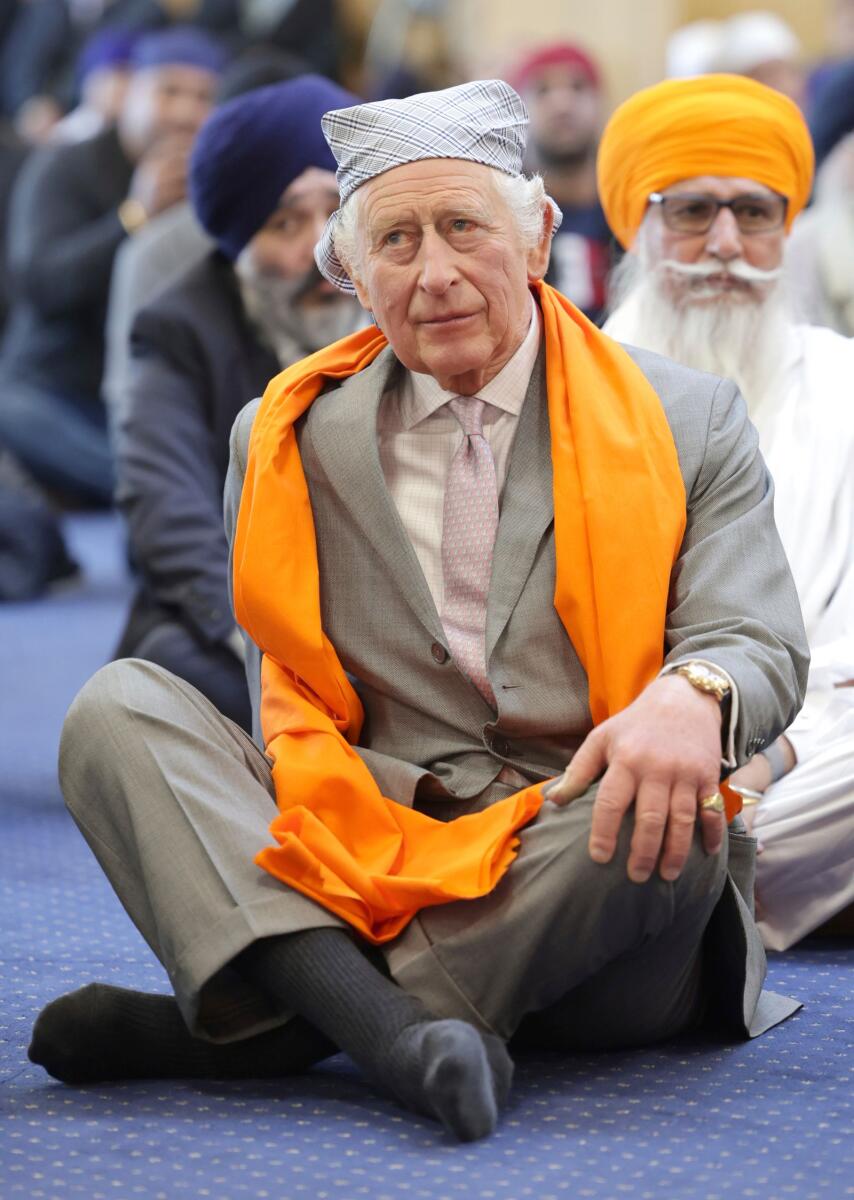 King Charles III sits on the floor in the Prayer Hall during a visit to the newly built Guru Nanak Gurdwara, in Luton, England, Tuesday, Dec. 6, 2022. — AP file