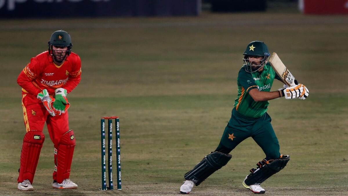 Babar Azam plays a shot while Zimbabwe’s wicketkeeper Brendan Taylor looks on during the 2nd one-day international.— AP