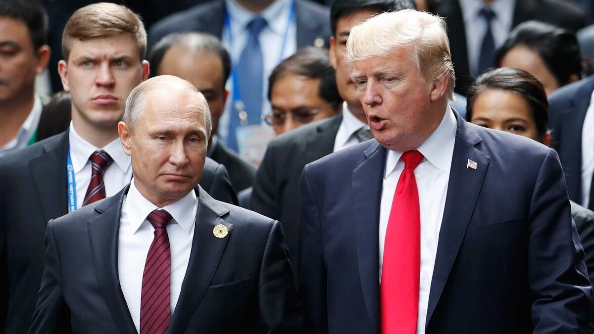US President Donald Trump and Russias President Vladimir Putin talking during a photo session.- AP file photo
