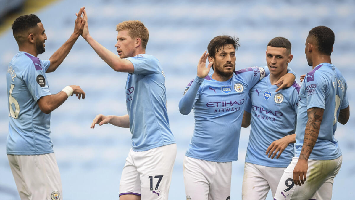 Manchester City players celebrate after scoring their second goal during the English Premier League match against Newcastle on Wednesday. - AP