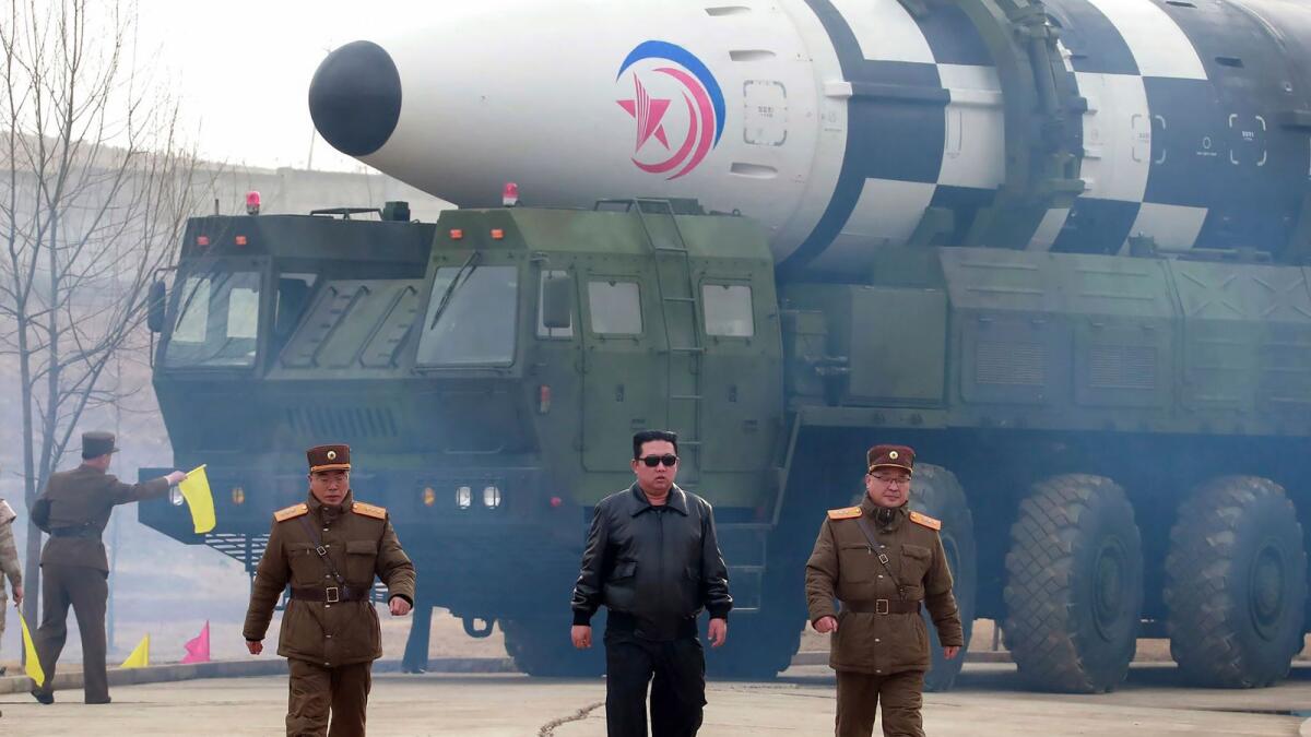 In this photo distributed by the North Korean government, North Korean leader Kim Jong Un, center, walks around what it says a Hwasong-17 intercontinental ballistic missile (ICBM) on the launcher, at an undisclosed location in North Korea on March 24, 2022. (Photo: AP)