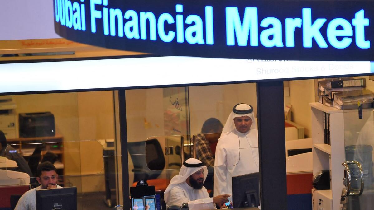 Traders at the Dubai Financial Market. — AFP file