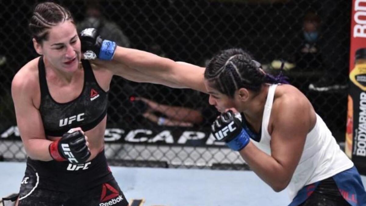 Cynthia Calvillo (blue gloves) punches Jessica Eye (red gloves) in their flyweight fight during UFC Fight Night (Reuters)
