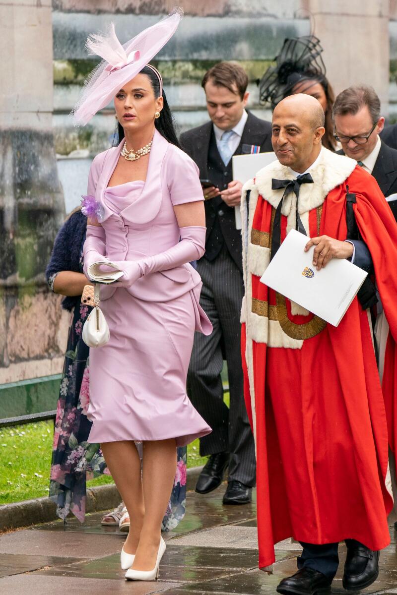 US singer Katy Perry, left, leaves Westminster Abbey following the coronation ceremony of King Charles III and Queen Camilla in London. (Jane Barlow/Pool Photo via AP)