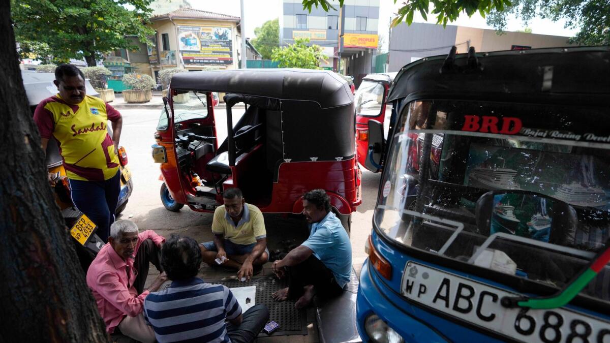 Auto rickshaw drivers wait to buy fuel in Colombo, Sri Lanka, Tuesday, July 5, 2022. Sri Lanka's ongoing negotiations with the International Monetary Fund have been complex and difficult than the instances before because it has entered talks as a bankrupt nation, the country's prime minister said Tuesday. (AP Photo/Eranga Jayawardena)