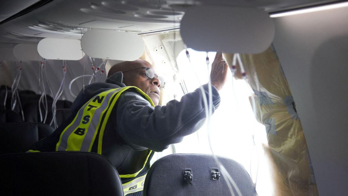 National Transportation Safety Board (NTSB) Investigator-in-Charge John Lovell examines the fuselage plug area of Alaska Airlines Flight 1282 Boeing 737-9 MAX, which was forced to make an emergency landing with a gap in the fuselage, in Portland, Oregon. — Reuters