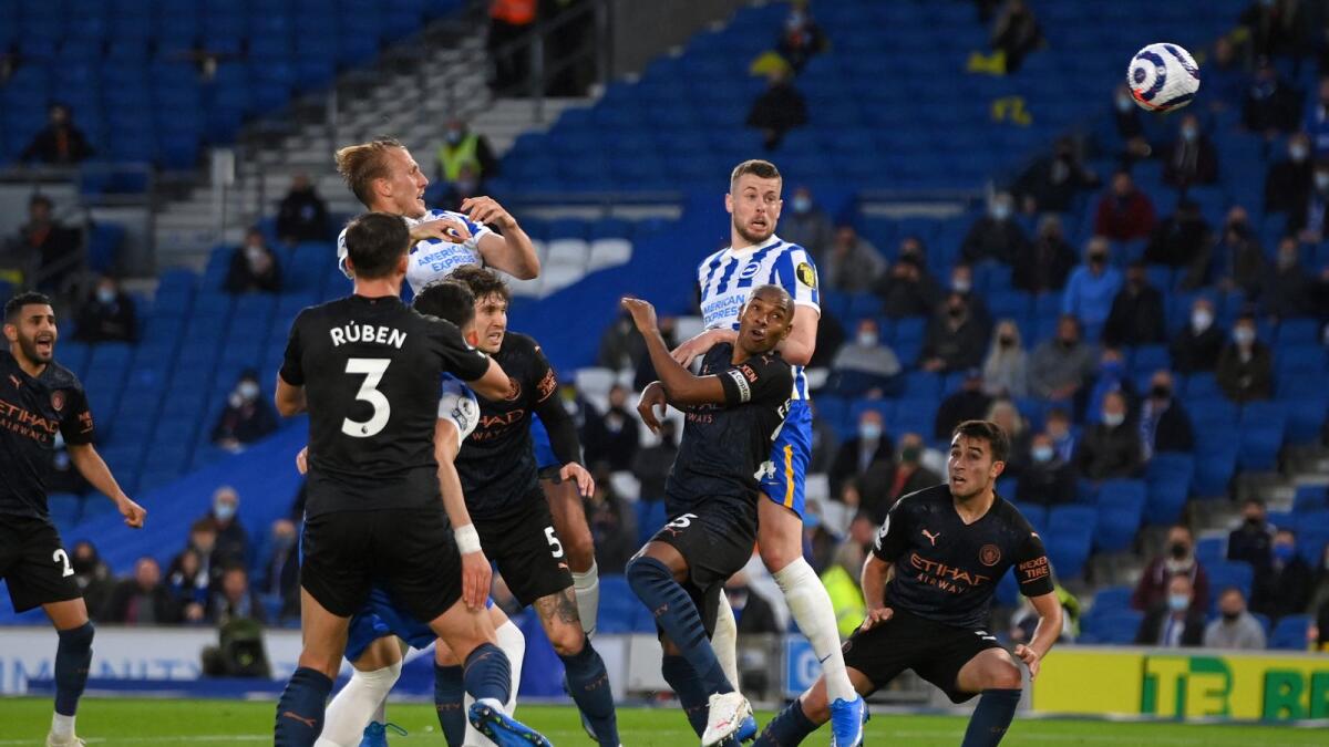 Brighton's Adam Webster (centre) scores his team's second goal during the Premier League match against Manchester City. (AFP)