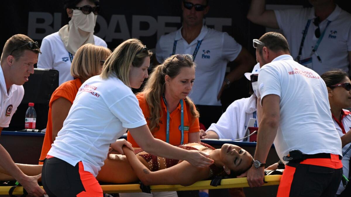 Anita Alvarez is taken on a stretcher from the pool. (AP)