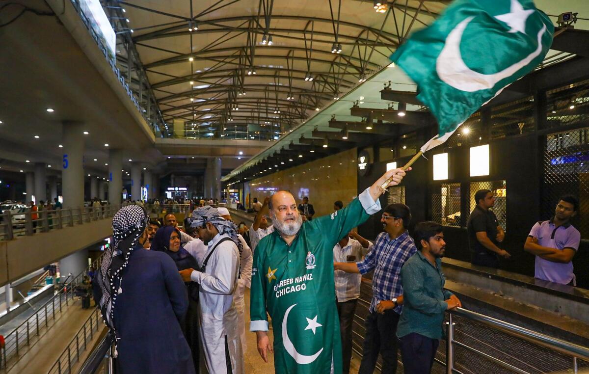 Pakistani fan Chacha Chicago waves the country's national flag during the Pakistan team's arrival at the Rajiv Gandhi International Airport, in Hyderabad on Wednesday. — PTI