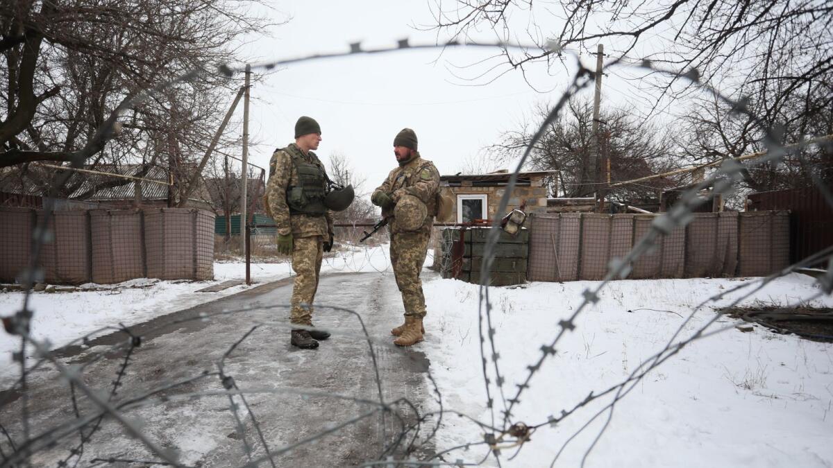 Ukrainian military forces' servicemen stand guard in Mariinka, on the front line with Russia-backed separatist, Donetsk region, on February 7, 2022. (Photo: AFP)