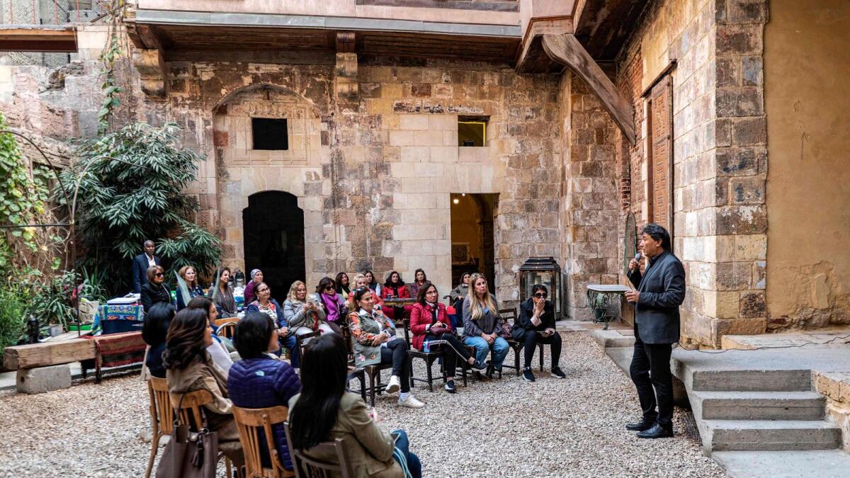 Egyptian architect Alaa el-Habashi, owner of the restored historical 'Beit Yakan' house in the al-Darb al-Ahmar district of Cairo, speaks to visitors on December 6, 2022.  — AFP