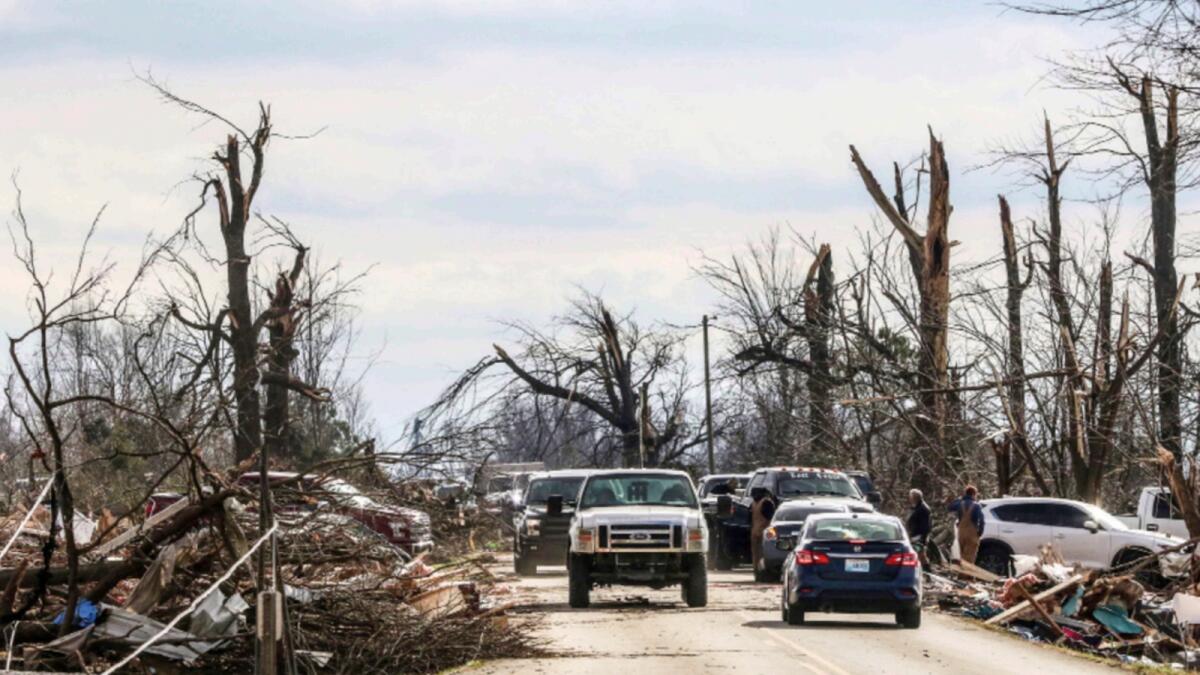 Rescue workers and officials line Kentucky 81 in Bremen working to clean up the area after a powerful tornado swept through on Friday night. — AP