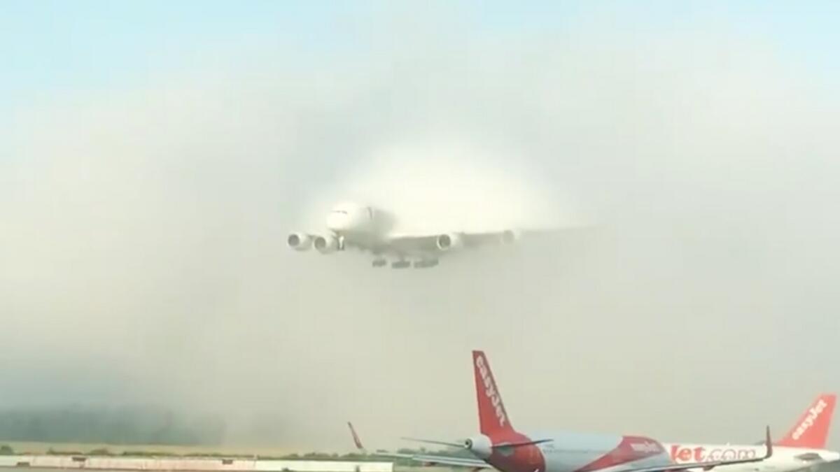 Emirates A380, landing, clouds