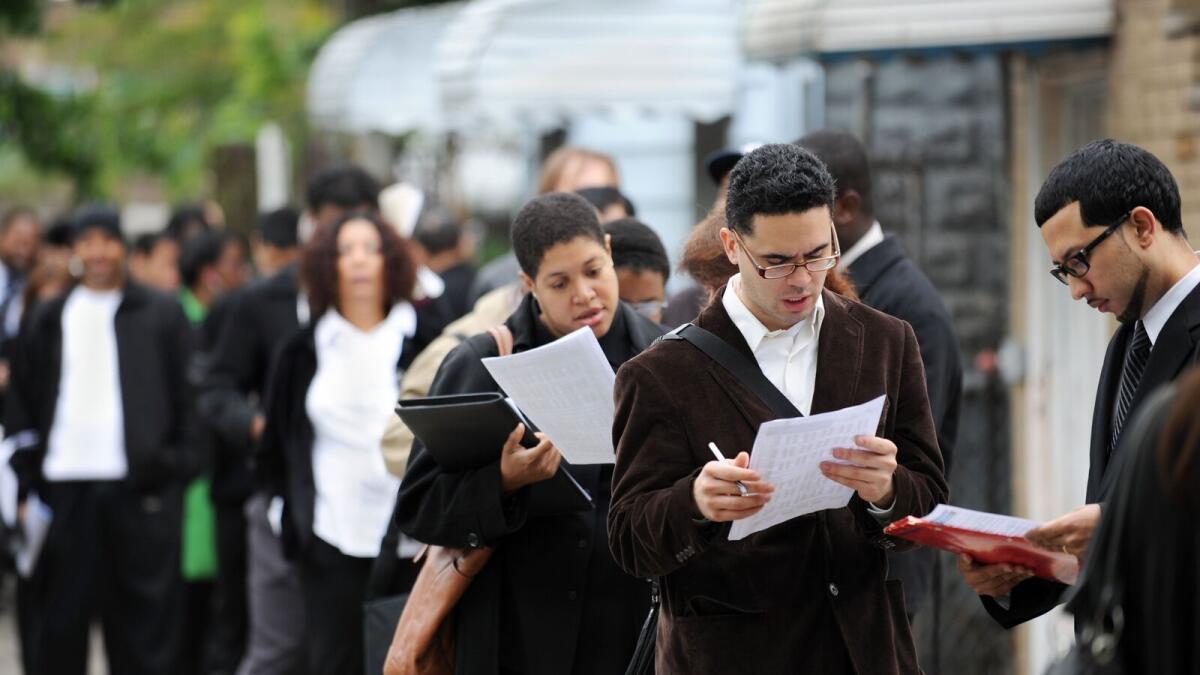 Job seekers wait in line at an employment fair in New York. Nonfarm payrolls increased by 263,000 jobs last month, the Labour Department said in its closely watched employment report on Friday. - File photo