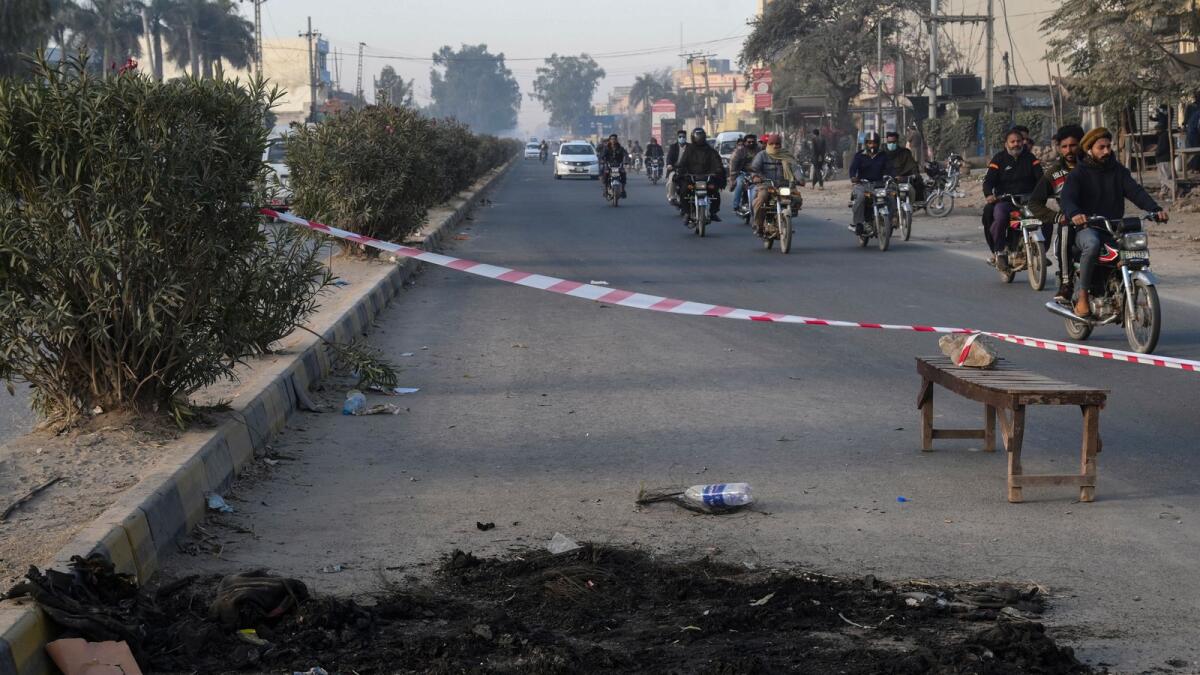 Area cordoned off by the police of the site where a Sri Lankan factory manager was earlier beaten to death by a mob outside a factory in Sialkot on December 4, 2021. (Photo: AFP)