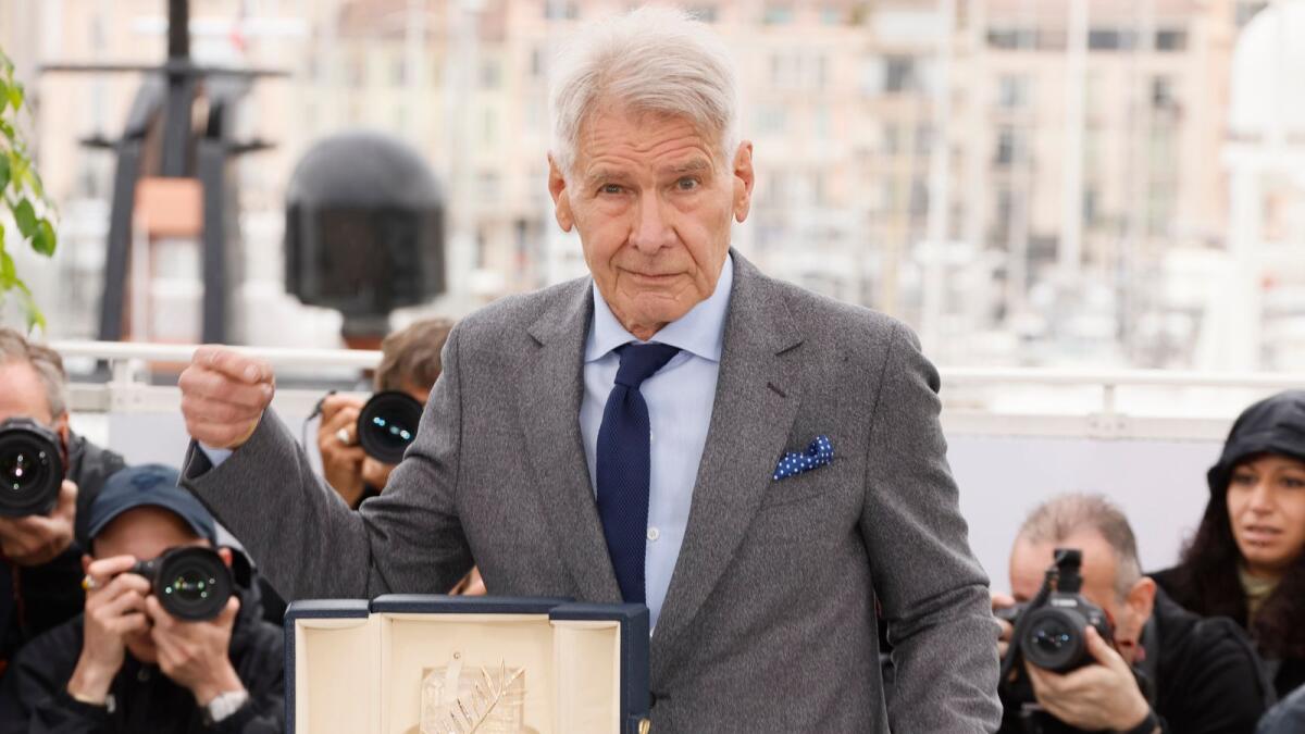 Harrison Ford poses for photographers with his honorary Palme d'Or at the photo call for the film 'Indiana Jones and the Dial of Destiny' at the 76th international film festival, Cannes. — AP