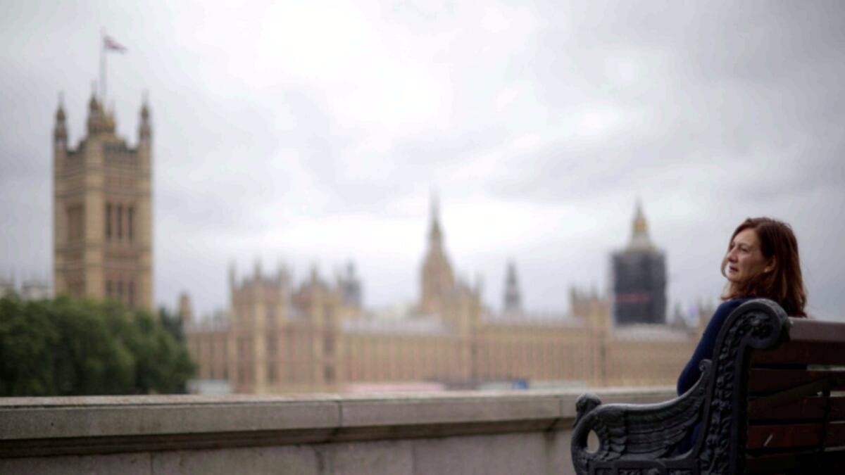 A woman looks at the Houses of Parliament in London. — Reuters