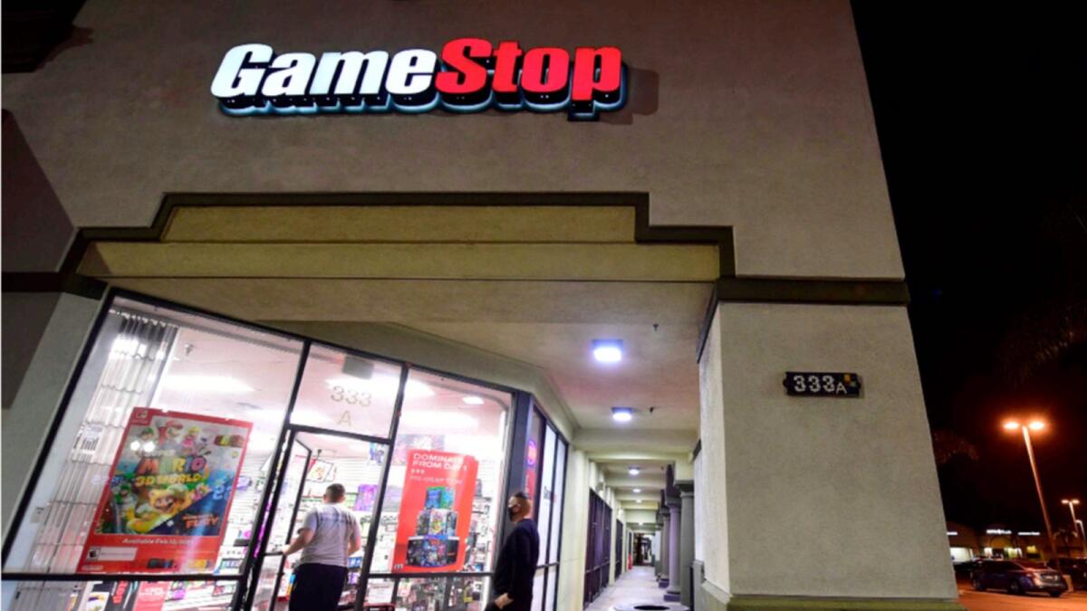 People enter a GameStop store in Alhambra, California. — AFP