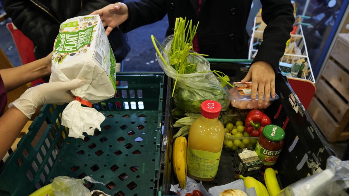 Rising food, energy and housing costs are set to wipe out the savings of a fifth of British households. AP file