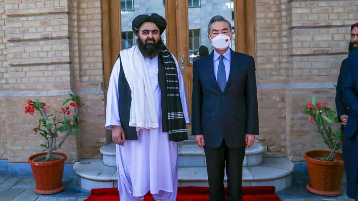 Taliban Foreign Minister Amir Khan Muttaqi (left) poses with China's Foreign Minister Wang Yi in Kabul. – AFP