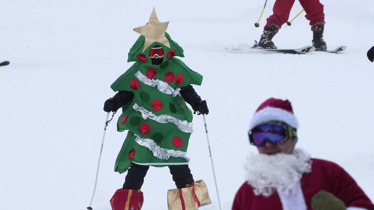 A skier dressed as a Christmas tree skis for charity.