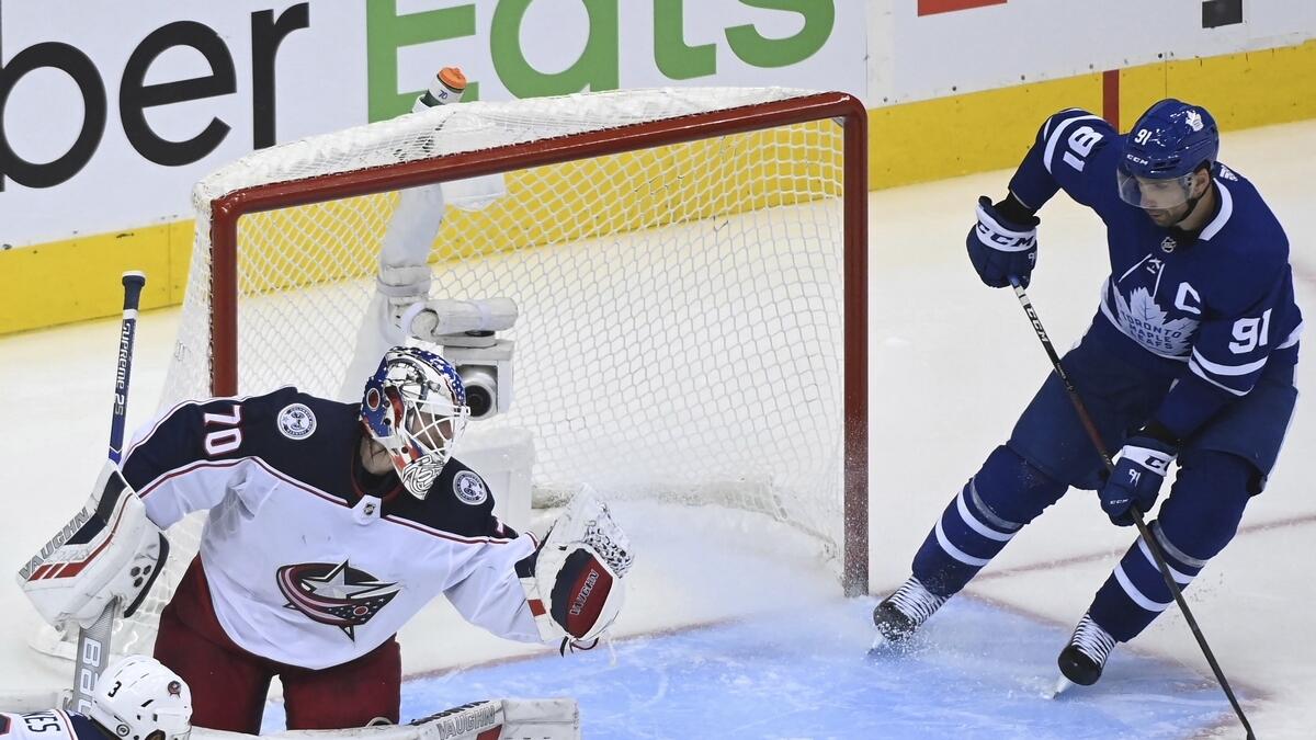 Columbus Blue Jackets goaltender Joonas Korpisalo (70) makes a save as Toronto Maple Leafs center John Tavares (91) looks for a rebound during the third period of an NHL Eastern Conference Stanley Cup playoff game in Toronto