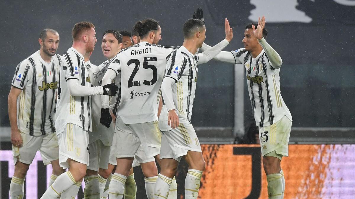 Juventus' Cristiano Ronaldo (second right) celebrates his goal with his teammates against Roma. — AFP