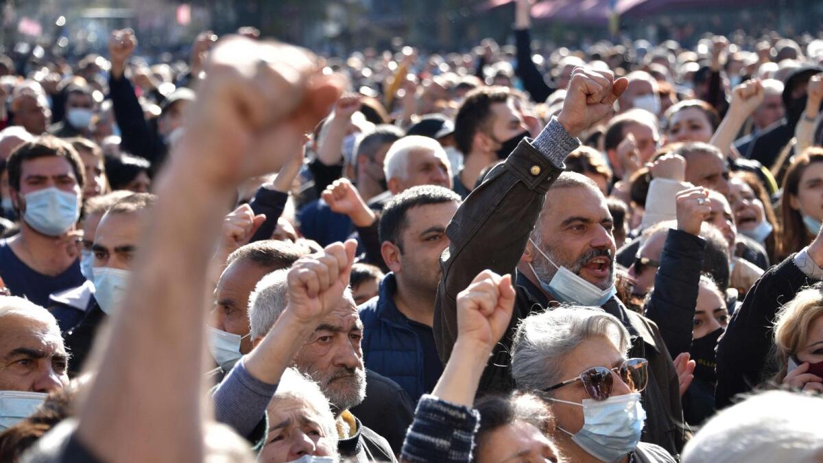 People of Armenia protest during a rally against the government’s agreement to end fighting with Azerbaijan over the disputed Nagorno-Karabakh region outside the government headquarters in Yerevan.